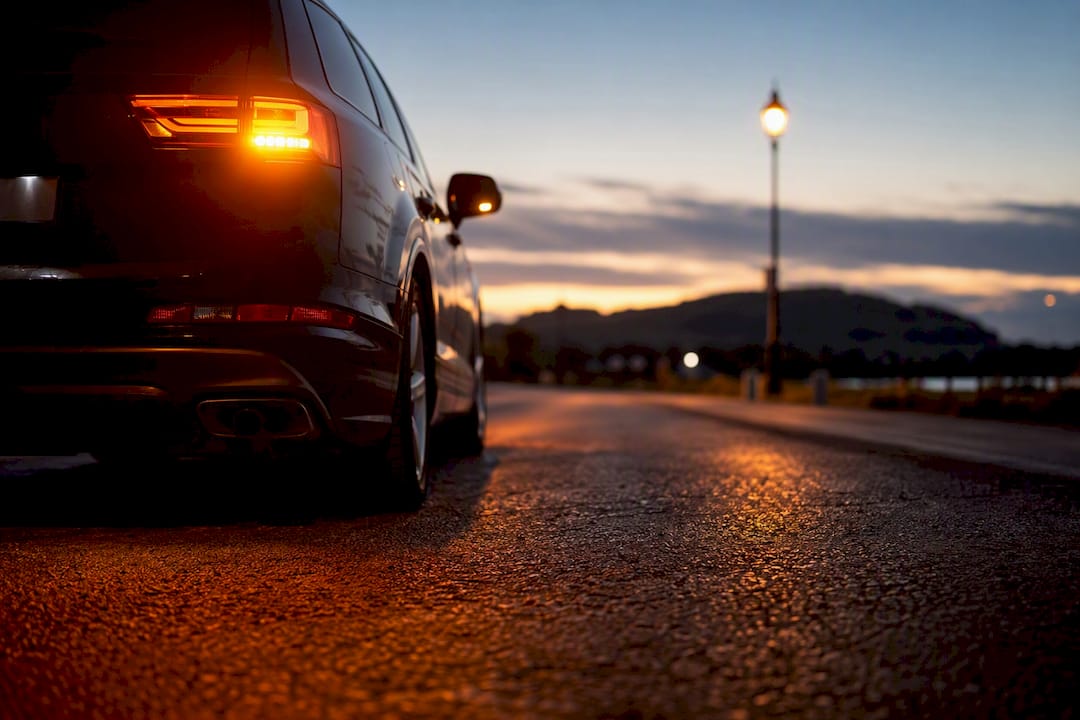 Car pulled over with hazard lights blinking at dusk