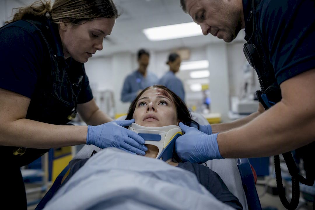 Paramedic securing cervical collar after car crash