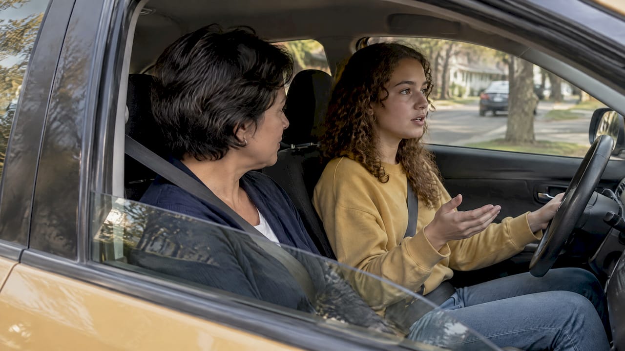 Parent and teen practicing passenger safety rules