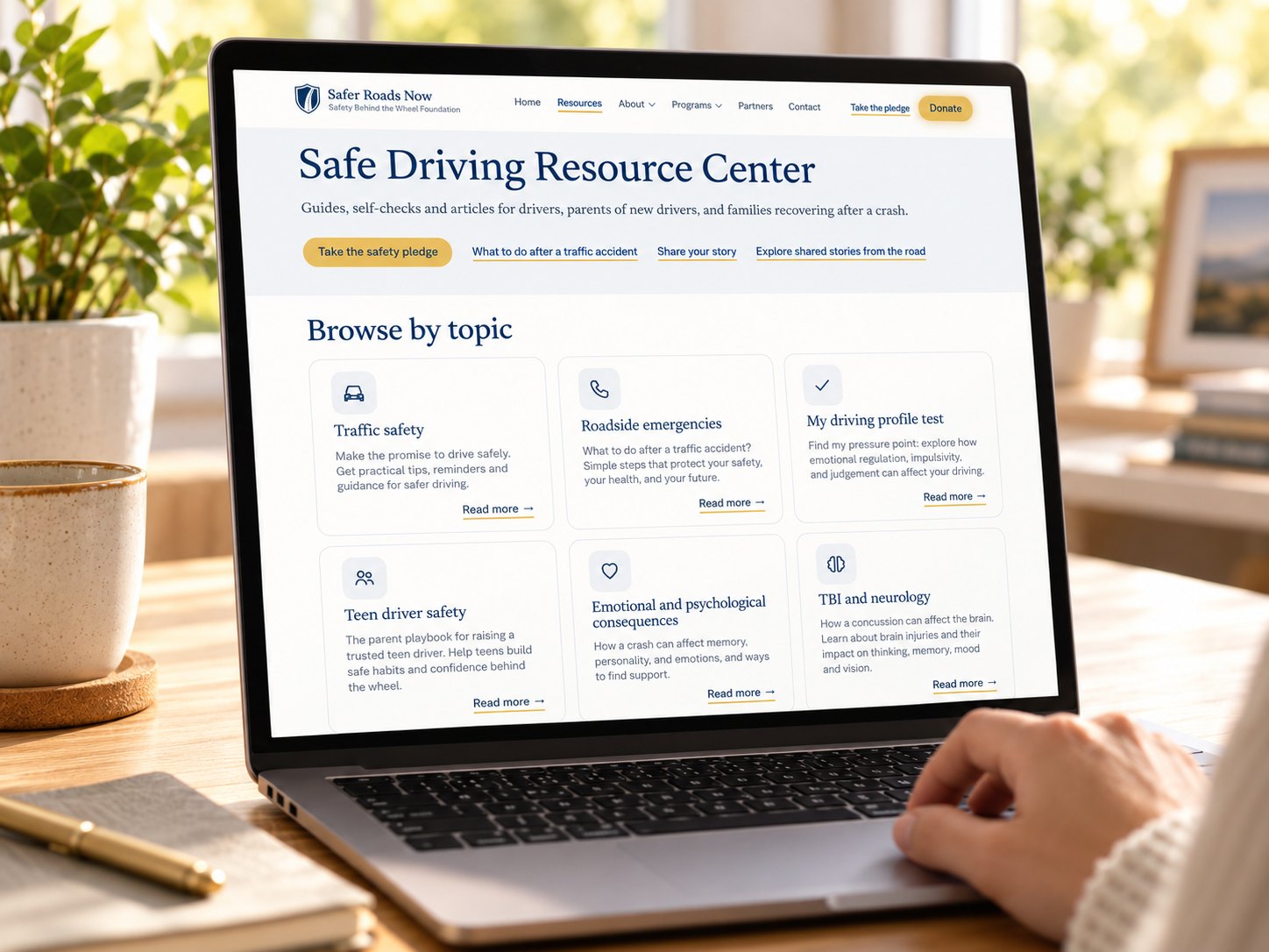 A laptop open to the Safe Driving Resource Center page, with guides grouped by topic.